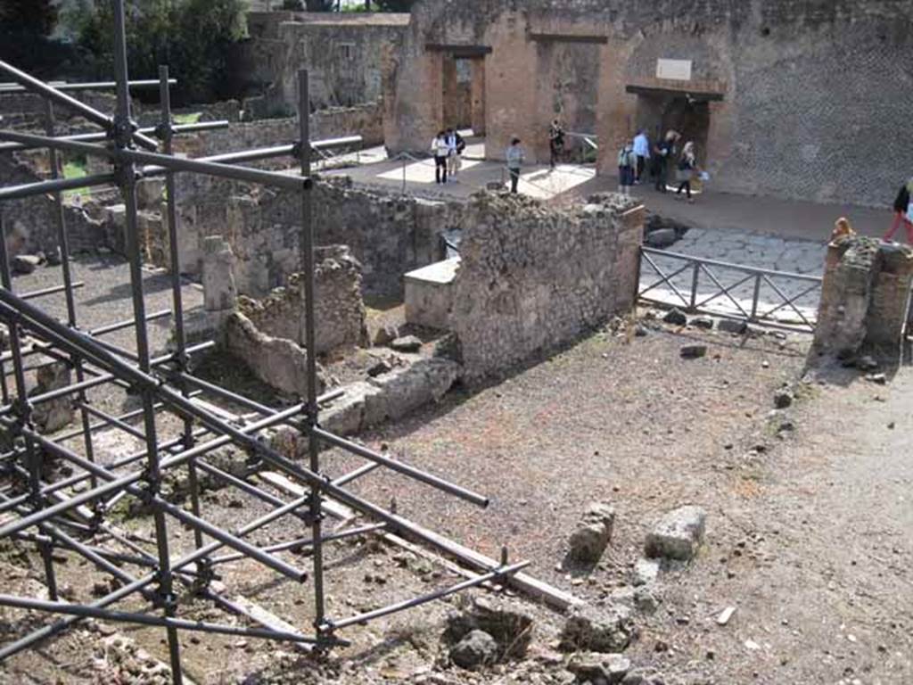 I.2.15 Pompeii. September 2010. Looking south-west from end of corridor on top of collapse. Photo courtesy of Drew Baker.
According to Garcia y Garcia, all the west part of the dwelling was completely destroyed in 1943. The bomb demolished the upper floor, leaving the cistern below uncovered and visible. See Garcia y Garcia, L., 2006. Danni di guerra a Pompei. Rome: L’Erma di Bretschneider.  (p.37)