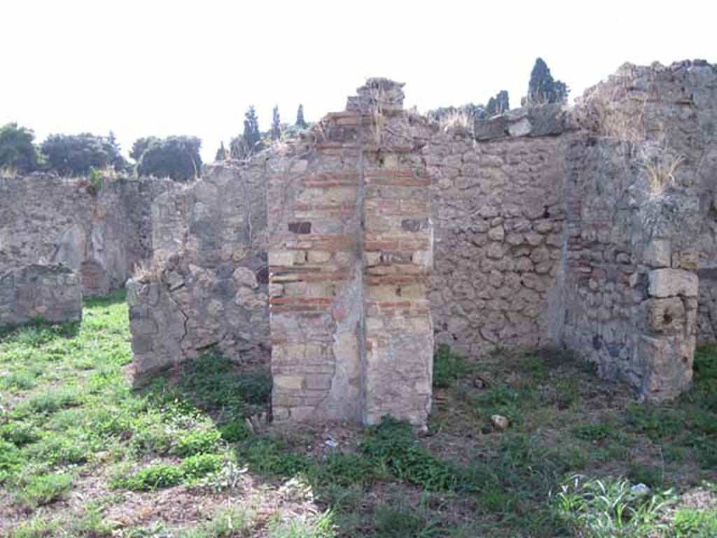 I.2.17 Pompeii. September 2010. Looking west at north-west corner of portico in garden peristyle. On the left is the doorway to room 12, and on the right is the doorway to room 14. Photo courtesy of Drew Baker.