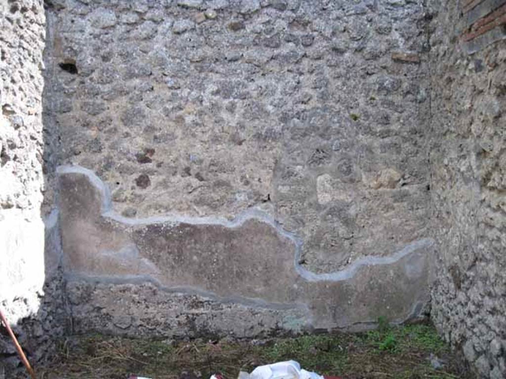 I.2.18 Pompeii. September 2010. Looking south through doorway into rear room in south-west corner. Photo courtesy of Drew Baker. When this room was excavated, the wall was painted in the III style, with a central aedicula. On its sides were a red panel and a yellow panel into the corner, separated from it by a narrow black compartment.