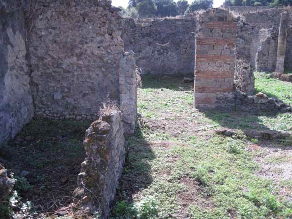 I.2.24 Pompeii. September 2010. Looking west along south portico, from south-east corner. The middle of the three rooms and its doorway, can be seen on the left. Photo courtesy of Drew Baker.