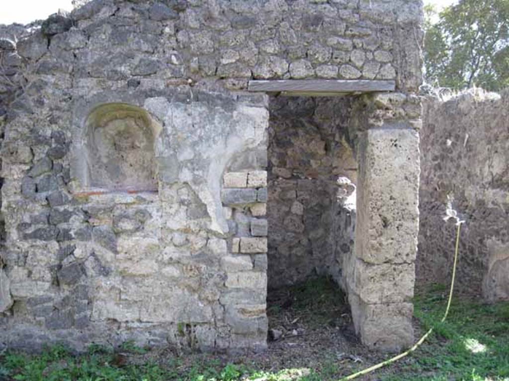 I.2.24 Pompeii. September 2010. West half of south wall of atrium, with niche and small doorway to room (cupboard or repository) that would have been under the stairs. Photo courtesy of Drew Baker.
