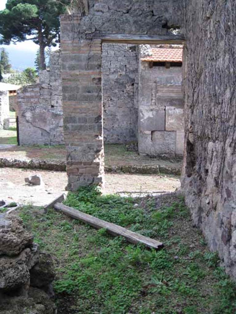 I.2.25 Pompeii. September 2010. Looking south along west side, towards entrance doorway of I.2.26 on Vicolo del Conciapelle.  Photo courtesy of Drew Baker. This entrance would have been a separate stairs to an upper dwelling and workshop. Beneath the stairs would have been a latrine