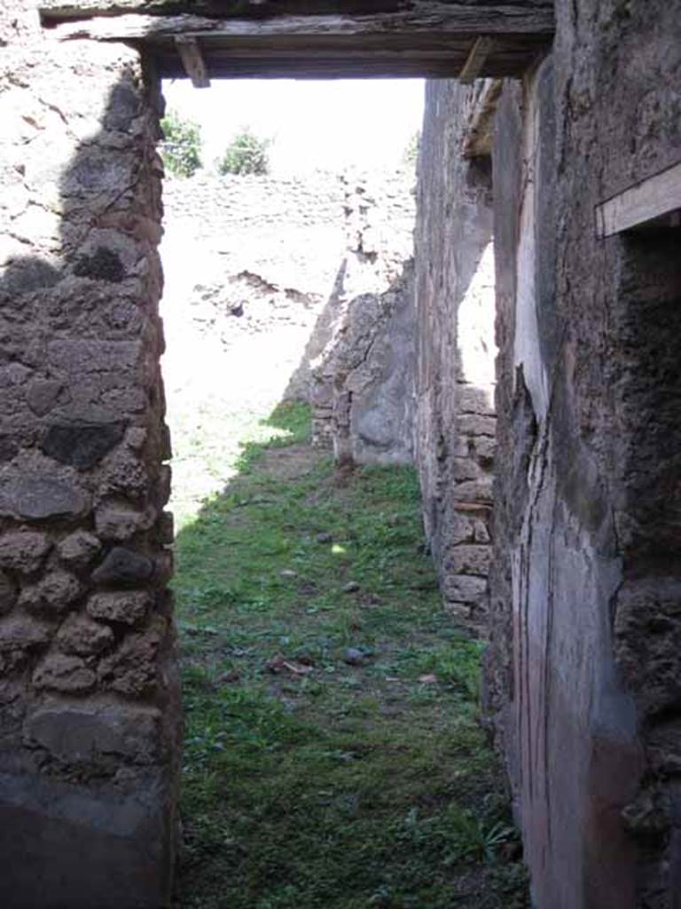 I.2.28 Pompeii. September 2010. East wall of room on south side of triclinium with doorway to south portico. On the right, in the centre of the photo would be the doorway to the tablinum. Photo courtesy of Drew Baker