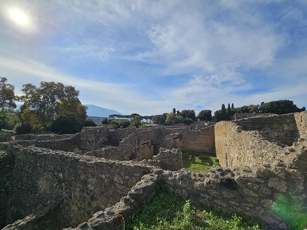 I.2.28 Pompeii. November 2024. 
Looking west along the north side, centre right, towards triclinium in peristyle garden area, photo taken from I.2.20. 
Photo courtesy of Annette Haug.