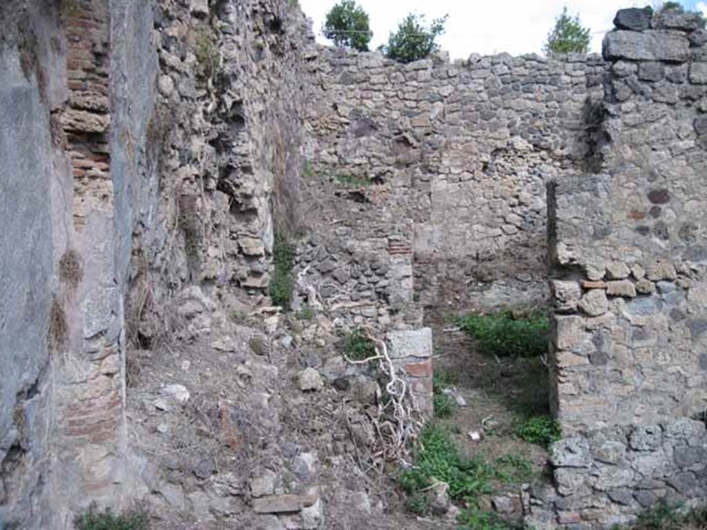I.2.28 Pompeii. September 2010. Doorway to rooms in north-east corner of garden area, looking east. The remains of the steps to the upper floor are on the left. Photo courtesy of Drew Baker.