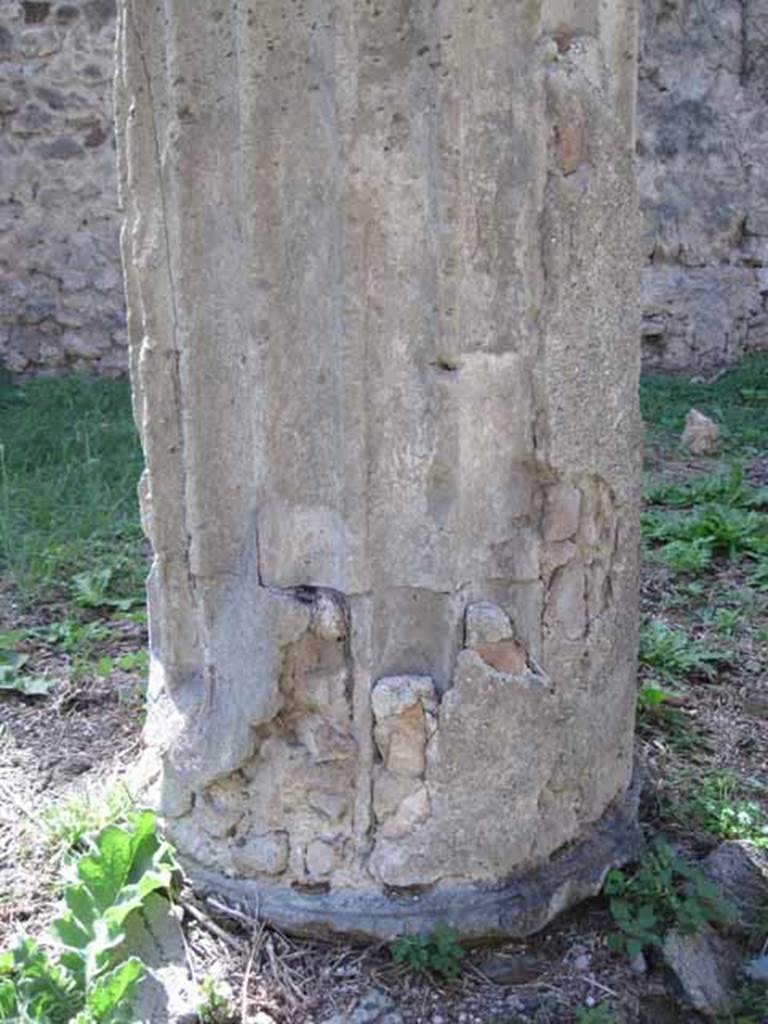I.2.28 Pompeii. September 2010. Detail of column base of the south west column. (Note original column fluting filled in and plastered over). Photo courtesy of Drew Baker.