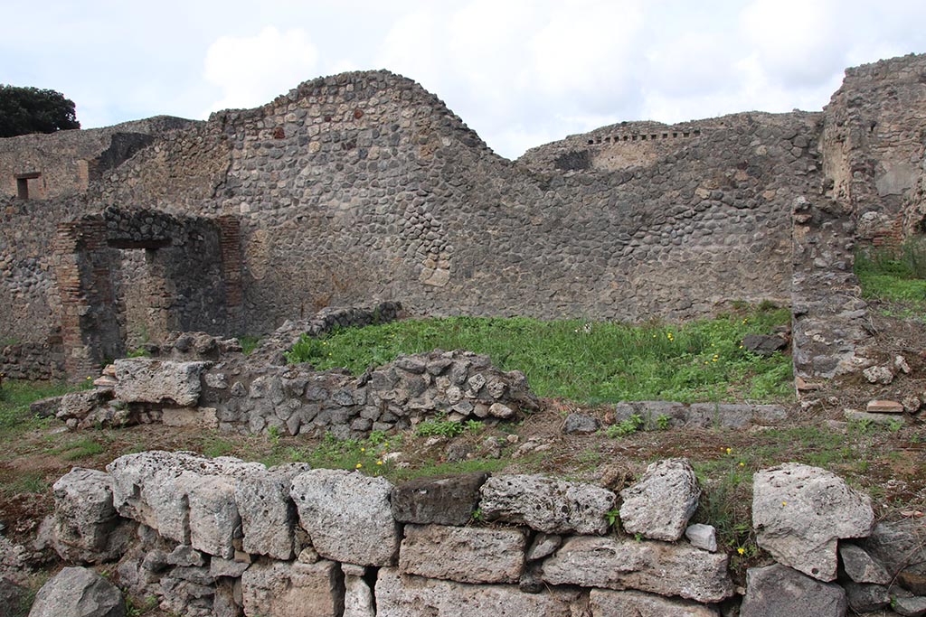 I.2.30 Pompeii. October 2024. 
Looking north on Vicolo del Conciapelle towards entrance doorway into room on east side of I.2.31, with I.2.32 and I.2.1, on left.
Photo courtesy of Klaus Heese.