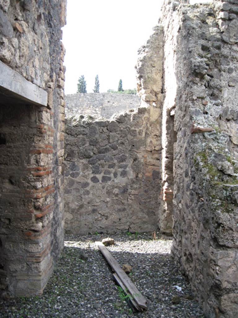 I.3.3 Pompeii. September 2010. Looking west across area of wider corridor. On the left is one of the doorways to the kitchen, followed by the entrance to the small corridor or latrine.
On the right can be seen the doorway leading to the atrium, and the edge of the doorway to the second triclinium. Photo courtesy of Drew Baker.