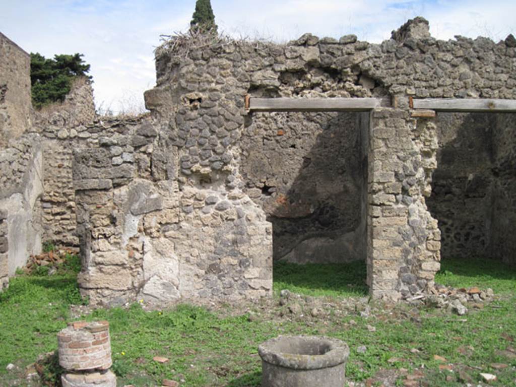 I.3.3 Pompeii. September 2010. Upper peristyle area, looking east towards three doorways from east portico. The two doorways on the left lead into cubicula. The doorway on the right led into a room with a staircase. Photo courtesy of Drew Baker.