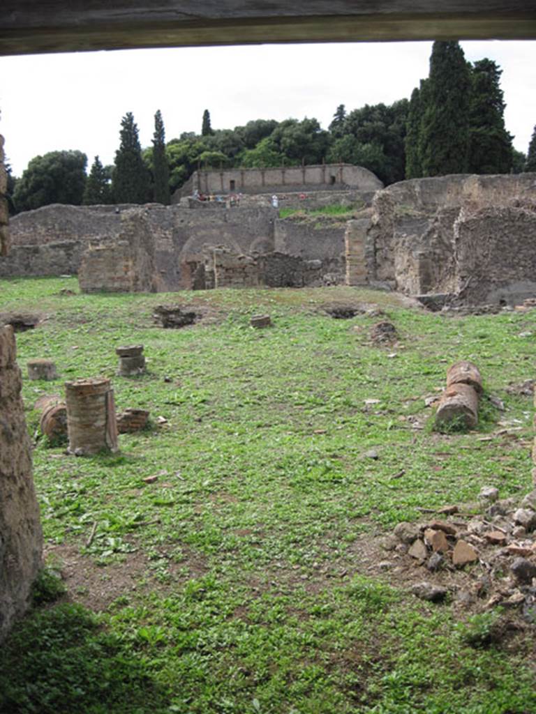 I.3.3 Pompeii. September 2010. Upper peristyle area, looking west through doorway of small room with staircase across the east portico to the peristyle. Photo courtesy of Drew Baker.