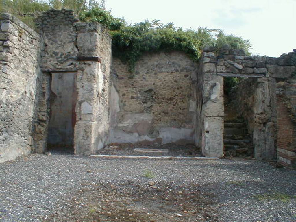 I.3.3 Pompeii. September  2004. Looking east across atrium to doorways to triclinium, tablinum and steps to upper floor.