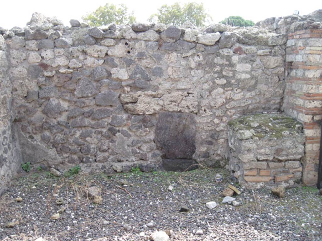I.3.7 Pompeii. September 2010. South wall of shop, with brick podium in south-west corner. 
Photo courtesy of Drew Baker.