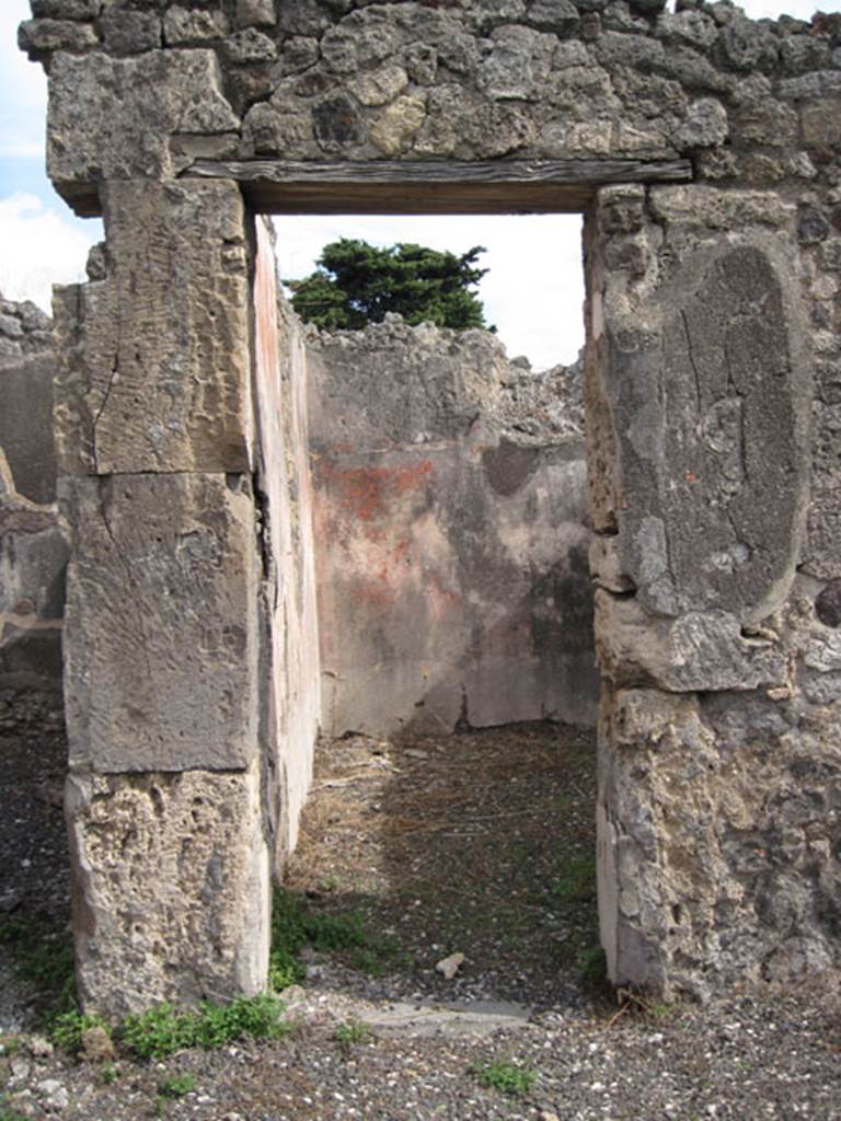 I.3.8b Pompeii. September 2010. Looking east through southern doorway in east wall of tablinum, into a cubiculum. Photo courtesy of Drew Baker.