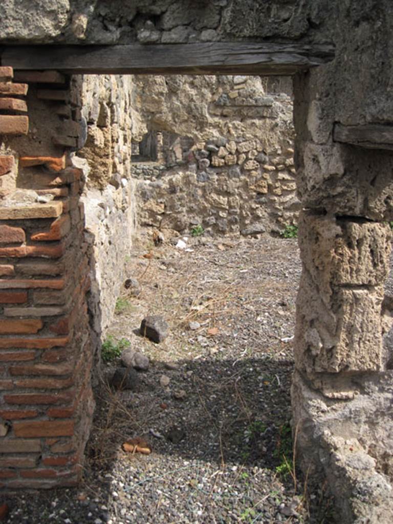 I.3.8b Pompeii. September 2010. Looking east through doorway into kitchen, at east end of corridor. Photo courtesy of Drew Baker.