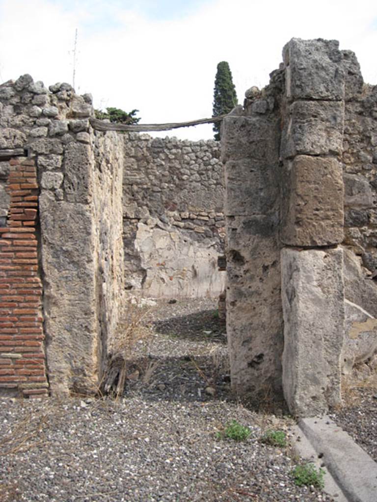 I.3.8b Pompeii. September 2010. Looking east towards doorway in south-east corner of peristyle, into a small ruined vestibule, which would have had two doorways leading from it. 
One leading perhaps to a cubiculum on the east side with window into corridor/kitchen.
The other leading to a room on the south side. Photo courtesy of Drew Baker.