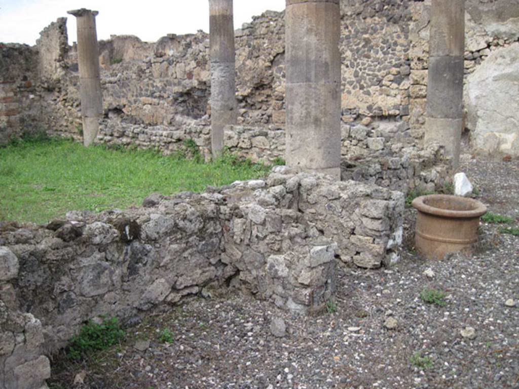 I.3.8b Pompeii. September 2010. Looking towards features near west garden wall of east portico. Photo courtesy of Drew Baker.
See Jashemski, W. F., 1993. The Gardens of Pompeii, Volume II: Appendices. New York: Caratzas. (p.26).
According to Warscher, “Non è rimasto niente della testa di Vulcano menzionata dal Mau (Bull. Inst. 1871, p. 171). Ma questo testa non è sola testa di terracotta che è stata trovata sul forno di Pompei: prima di quella hanno scavato il forno nel pistrino IX.1.3/30, nel quale è incastrata una testa – del Vulcano o forse dello spirito del fuoco – anche di terracotta, ma di quest’ultima io non ho trovato nessuna menzione. (vedi, il mio Codex Topographicus di Pompei IX, 1). Anche in questo caso sotto la testa di terracotta si trova un fallo”.
See Warscher, T, 1935: Codex Topographicus Pompejanus, Regio I, 3:Rome, DAIR.  
(translation: “Nothing remained of the head of Vulcan mentioned by Mau (Bull. Inst. 1871, p.171) But this head was not the only terracotta head that had been found on a Pompeii oven: before this they had excavated the oven in the bakery in IX.1.3/30, in which was embedded a head – of Vulcan or maybe of the spirit of the fire, – also in terracotta, but of this last I have found no mention. (see my Codex Topographicus of Pompeii IX, 1). 
Also in that case, a phallus was found under the terracotta head.”)