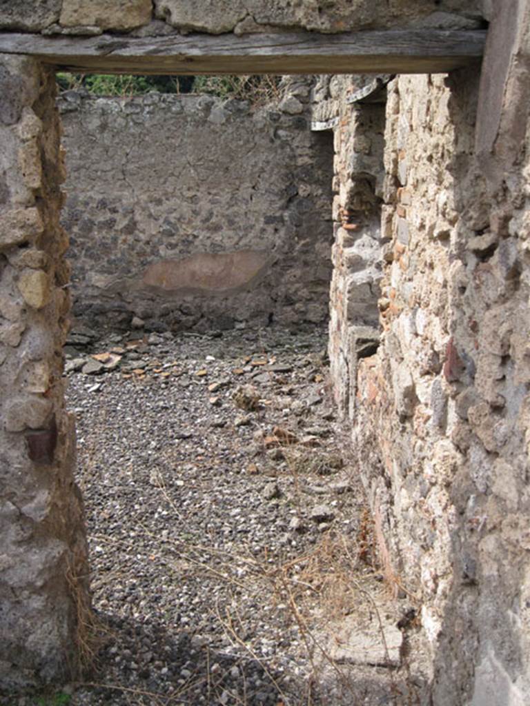I.3.8b Pompeii. September 2010. Looking west from exedra through doorway at western end of south portico. Photo courtesy of Drew Baker.