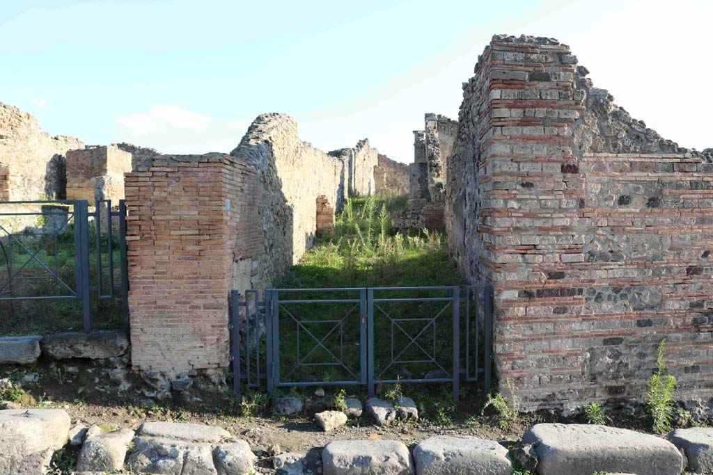 I.3.8 Pompeii. December 2018. Looking east from across via Stabiana towards entrance to angiportus or alleyway. 
This angiportus provides access to two distinctly separate houses.
I.3.8a with entrance on right of main corridor. I.3.8b House of Vulcanus with entrance straight ahead. Photo courtesy of Aude Durand.