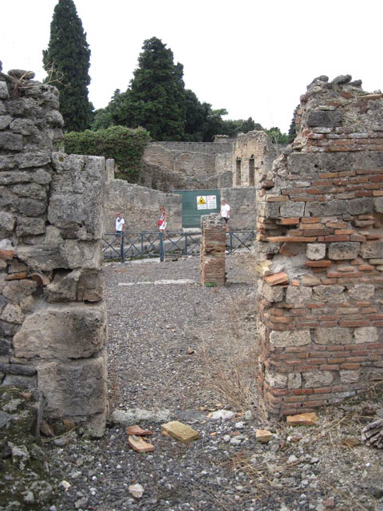I.3.10 Pompeii. September 2010. Looking west through doorway from rear of property.
On the left can be seen the entrance to the western room of the three in the south-east corner. Photo courtesy of Drew Baker.