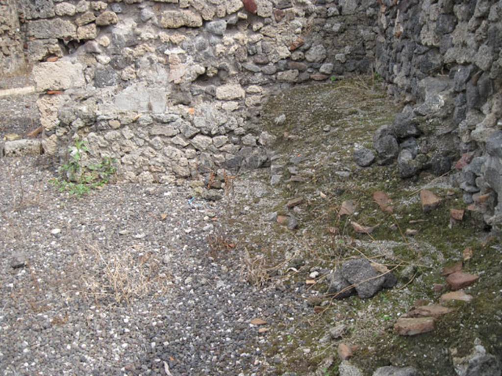I.3.10 Pompeii. September 2010. Looking east in first rear room on south side, towards the south-east corner. On the right, a raised platform feature can be seen against the south wall. On the left, tubs can be seen against the east wall. Photo courtesy of Drew Baker.
According to Fiorelli, this area was a workshop with extra rooms, altered however from their antique configuration by the passage and tunnelling of the Sarno canal. The canal was constructed by Fontana (1594-1600). Now one only sees the remains of the washhouses and the furnaces, that once existed here.
See Pappalardo, U., 2001. La Descrizione di Pompei per Giuseppe Fiorelli (1875). Napoli: Massa Editore. (p.39).