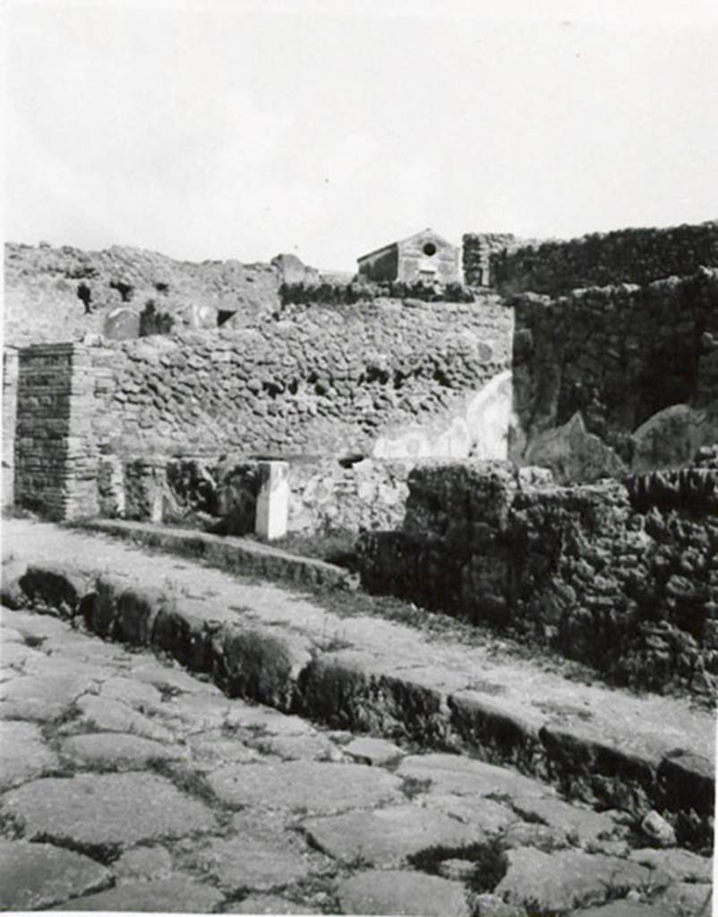 I.3.11 Pompeii. 1935 photograph taken by Tatiana Warscher. Looking north-east towards entrance from Via Stabiana. 
See Warscher, T, 1935: Codex Topographicus Pompejanus, Regio I, 3: (no.28), Rome, DAIR, whose copyright it remains.  
According to Warcher, quoting Fiorelli, “There was a masonry podium on the inside left of the entrance of this shop, containing eight terracotta urns, annexed at the side was a room used by the customers.”