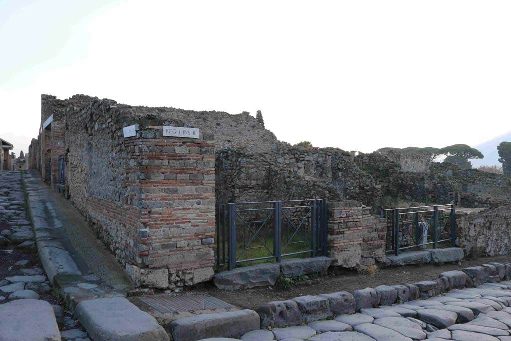 I.3.12 Pompeii, in centre. December 2018. 
Looking east towards entrance doorway on corner of Via Stabiana and its junction with Vicolo del Menandro. Photo courtesy of Aude Durand.