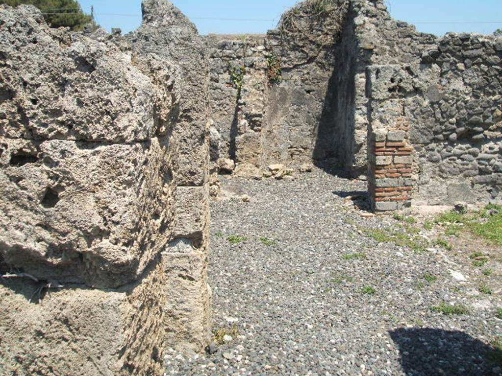I.3.20 Pompeii. May 2005. Looking east along north side of peristyle.
According to Jashemski –
The garden at the rear of the house had a passageway on the north and west.
There was a gutter around the east, north and west edges of the garden. 
Four large dolia were buried in the garden. A large triclinium along the east side of the garden had a window overlooking into the garden.
The remains of one couch of a masonry triclinium in the west passageway suggested to Fiorelli that formerly there might have been a room there, destroyed by the earthquake. There was a terracotta puteal in this passageway, and a small altar on the right-side of the peristyle.
See Jashemski, W. F., 1993. The Gardens of Pompeii, Volume II: Appendices. New York: Caratzas. (p.27).
According to Soprano –
Ubicazione: peristilio.
Bibliog. Fiorelli, op.c., p.56.
Il Fiorelli afferma che nell’ambulacro del peristilio c’erano tracce di ‘un letto tricliniare di fabbrica’.
Le tracce viste dal Fiorelli non sono oggivisibili.
See Soprano, P. (1950). I triclini all’aperto di Pompei. (In Pompeiana, raccolta di studi per il secondo centenario degli scavi di Pompei. Napoli, Gaetano Macchiaroli, Editore, p.308, no.36.