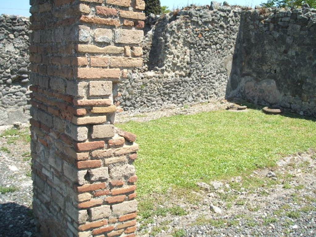 I.3.20 Pompeii. May 2005. Looking south-east towards two dolia buried in the peristyle. Originally there were four dolia.
See Van der Poel, H. B., 1986. Corpus Topographicum Pompeianum, Part IIIA. Austin: University of Texas. (p.6)
According to Boyce, on the right side of the peristyle stood a small altar, coated with stucco. On the yellow background, there were painted festoons and masks. The excavation report called it a lararium.
He gives the reference Bull.Inst., 1869, 242. This is no longer in situ.
See Boyce G. K., 1937. Corpus of the Lararia of Pompeii. Rome: MAAR 14. (p. 24)
