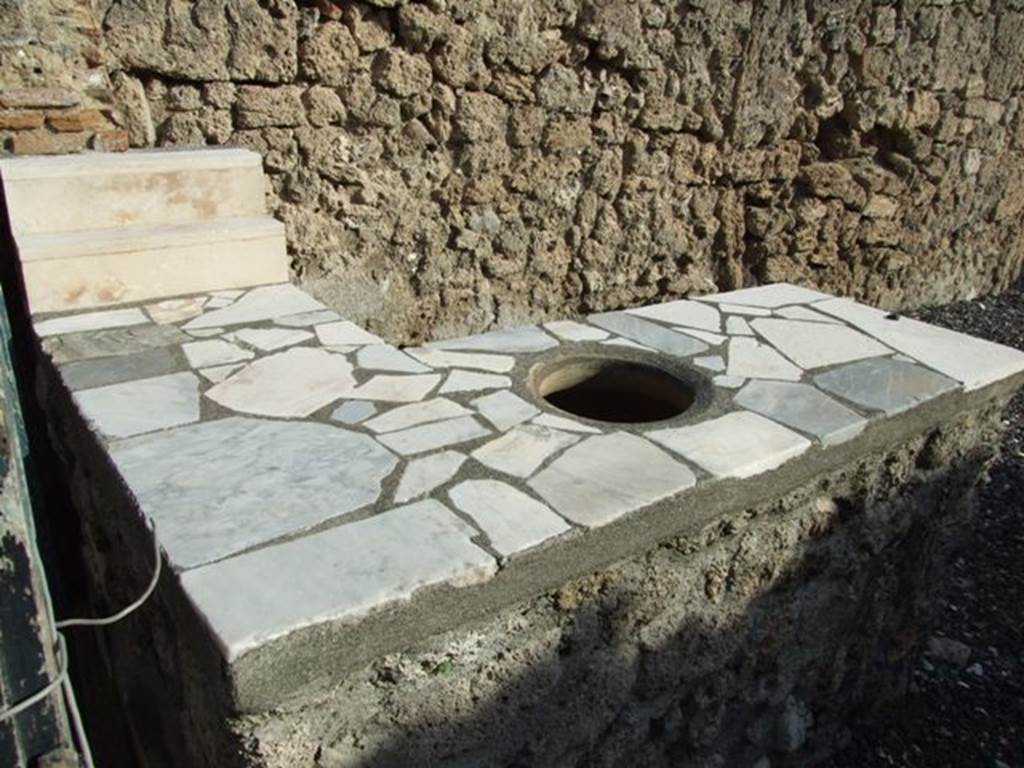 I.3.22 Pompeii.  December 2007.  Marble counter with two shelves for standing drinking vessels on and hole for a terracotta urn.