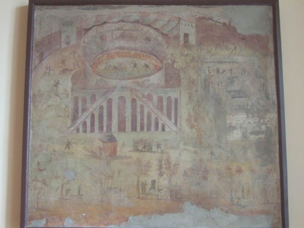 I.3.23 Pompeii. Rear wall of the peristyle. Painting of “Riot in the Amphitheatre” depicting the fight between the Nucerians and the Pompeians. 
Now in Naples Archaeological Museum. Inventory number 112222.
The famous episode narrated by Tacitus outlined what happened in Pompeii in 59 BC, when a brawl broke out in the amphitheatre during a gladiator show that led to an armed clash.
The event drew the attention of Emperor Nero, who ordered the Senate in Rome to investigate the incident. 
Following an inquiry by the consuls, reports Tacitus, Pompeii residents were banned from holding gladiator shows for 10 years, illegal associations were dissolved and the organizer of the games - former senator from Rome, Livineio Regulo - and all the others who were found guilty of incitement were exiled. 
In 2017 a new tomb SG6 was found at Porta Stabia with a 4 metre long inscription, which completes the information of Tacitus, it refers for the first time to the exile that would hit even the two top magistrates in office, the duoviri of the city.
Before now, the Tacitus passage, a fresco in the house of Actius Anicetus and three graffiti found on walls at Pompeii were the only explicit references to the amphitheatre riot of 59. 
The funerary inscription adds a key piece of information about this event. 
Thanks to the deceased’s personal relationship with Nero, he was able to persuade him to allow the two duoviri exiled as punishment for the brawl to return to Pompeii. 
This is the only reference to the duoviri having been exiled as well as the only reference to the intercessionary role the tomb occupant played. 
It opens up the possibility that he was involved in the softening and lifting of the 10-year ban on public events at the amphitheatre. 
It’s known that some combat spectacles like animal hunts took place during the first three years of the ban, and it was lifted entirely in 62 A.D. to celebrate the restoration of the amphitheatre after the earthquake.
The inscription therefore provides unpublished data on an important moment in Pompeii's political and institutional history, confirming the scenario of a nasty intrigue only outlined by Tacitus.
It is possible this was the tomb of Cn. Alleius Nigidius Maius, one of the most prominent characters of the Nero-Flavian era who is repeatedly acclaimed in Pompeii as a prolific provider of games, indeed he can be said to have been the best-known among the gladiatorial impresarios of the city.
