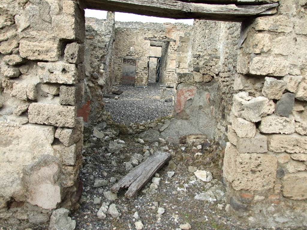 I.3.24 Pompeii. December 2006. Looking through room on north side of peristyle, across tablinum and atrium towards entrance doorway. According to Bull. Inst. –  The room on the right offered some medallions painted in a fine and gracious manner.  The subjects were ordinary. There was a Silenus with his crook, a mask, and a bust of Medusa. See BdI, 1869, p.239
According to Sogliano, found painted in the room on the north side of the garden were -
Head of Silenus, (nearly all vanished), p.41, no.172
Flying cupid with cornucopia, p.57, no.293
Flying cupid with alabastron on left shoulder, (destroyed), p.58, no.307
Flying cupid with his attribute vanished, p.60, no.342
Protome of Medusa, (destroyed), p.90, no.516
See Sogliano, A., 1879. Le pitture murali campane scoverte negli anni 1867-79. Napoli: Giannini. 
According to Fiorelli, “On the right of this same walkway was a room, adorned with three paintings of Cupids, and by a bust of Silenus, that looked into the adjoining triclinium through a wide window”.
See Pappalardo, U., 2001. La Descrizione di Pompei per Giuseppe Fiorelli (1875). Napoli: Massa Editore, (p.40)