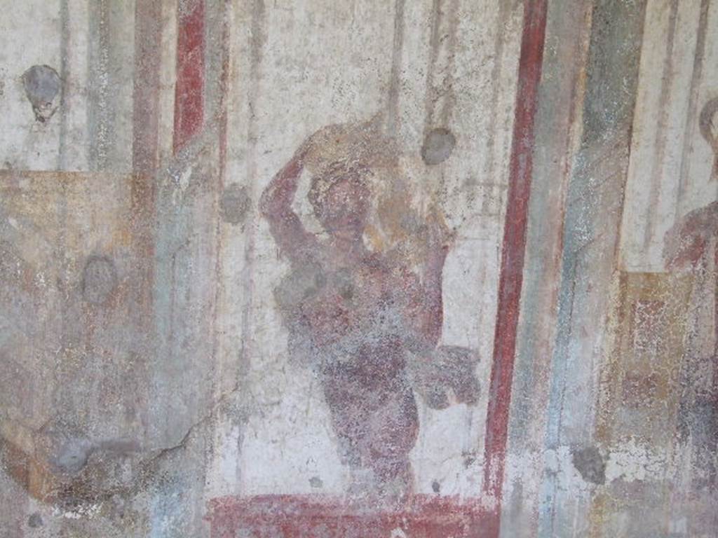 I.3.25 Pompeii. December 2006. South wall, with detail of wall painting of figure carrying a vase.