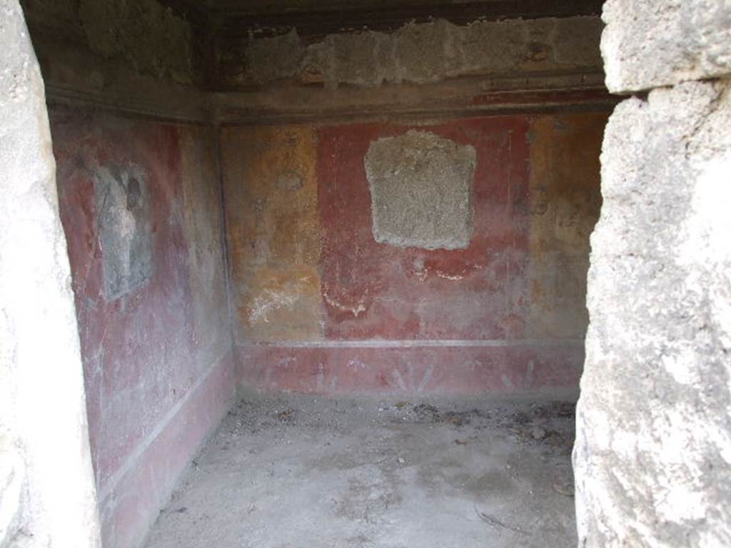 I.3.25 Pompeii. December 2006. Doorway to cubiculum on south side of peristyle, looking towards south-east corner. According to Trendelenburg, the colours of the surviving two paintings in this room were very faded. The details from the paintings could not be seen with certainty. However, the painting to the left of the doorway, on the east wall, represented Andromeda being liberated by Perseus. In the painting on the south wall, could be seen a young sitting man (perhaps Narcissus? - but according to Sogliano this was Ciparisso - See Sogliano, A., 1879. Le pitture murali campane scoverte negli anni 1867-79. Napoli: Giannini, p.28, no.109). The painting on the door (north) wall was destroyed, and the one on the west wall was replaced by a window. See Trendelenburg in BdI, 1871, (p.174-5)