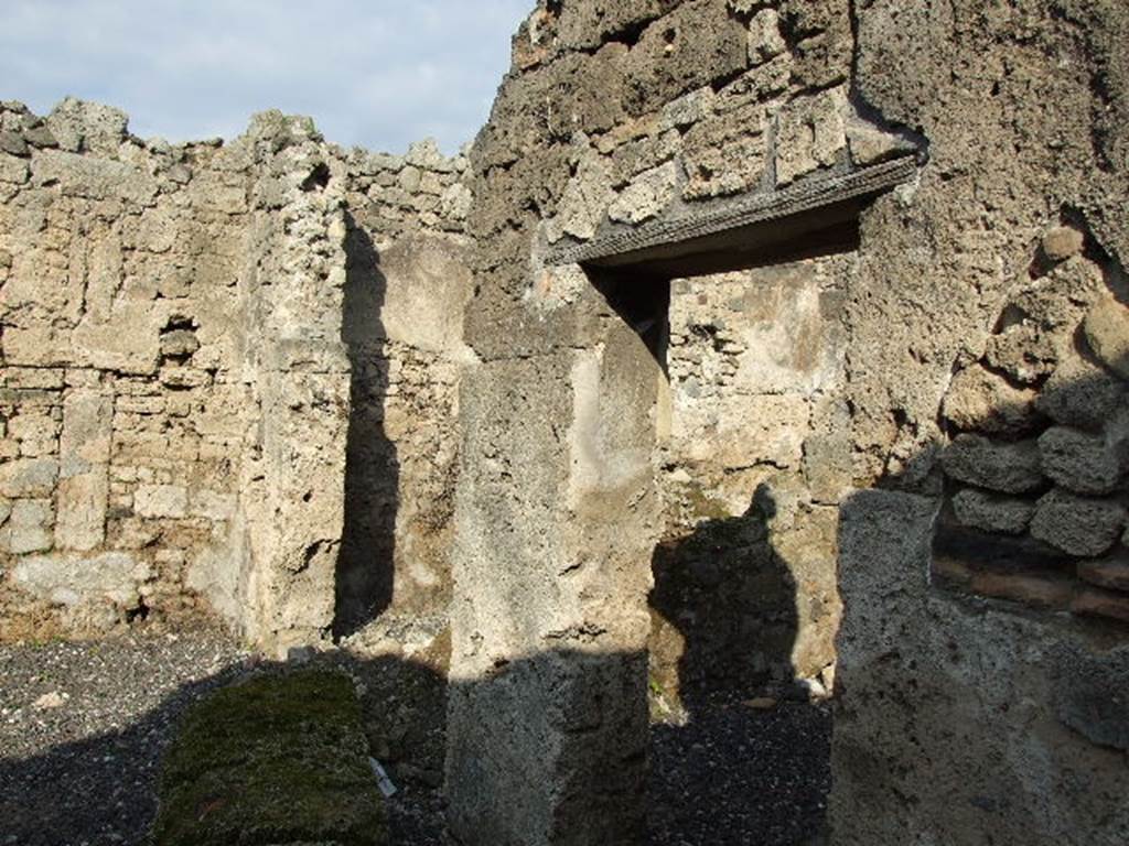 I.3.25 Pompeii. December 2006. Two doorways to rooms to north of entrance. The blocked niche can be seen in the east wall of the atrium, on the right of the photo.