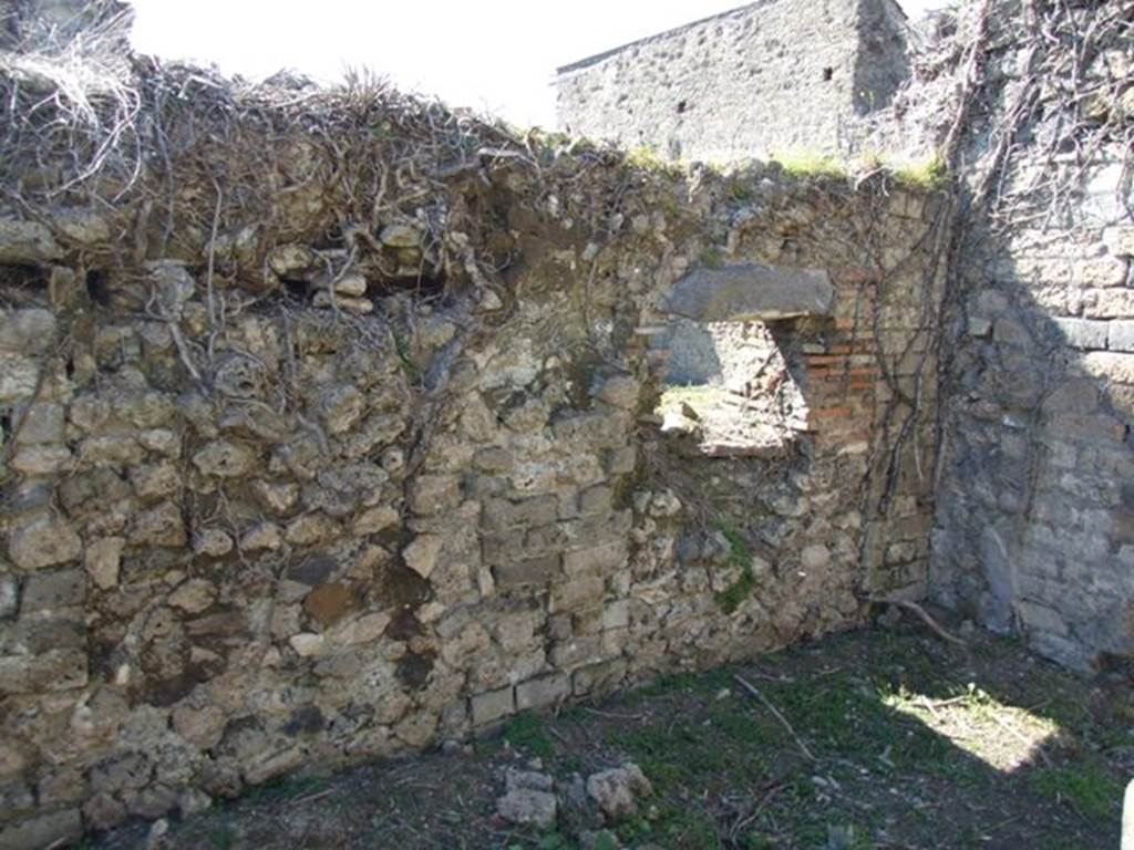 I.3.27 Pompeii. March 2009. West wall, with hatch to oven in room on the east side of the oven.