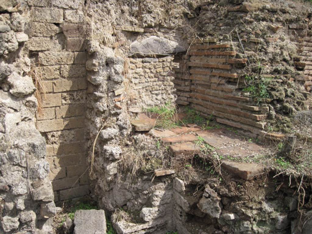 I.3.27 Pompeii. September 2010. Looking towards east wall and south-east corner of small area in front of oven.  The aperture into the room on the east side of the oven can be seen above the terracotta slabs. Photo courtesy of Drew Baker.