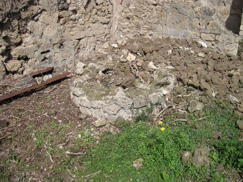I.3.27 Pompeii. September 2010. 
Looking east to circular feature (base of millstone) at east end of north wall of bakery room. 
Photo courtesy of Drew Baker.