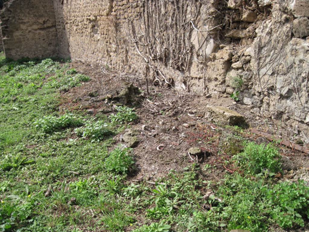 I.3.27 Pompeii. September 2010. 
Looking towards remains of circular feature (base of millstone) at west end of north wall of bakery room. 
Originally there would have been four millstones. Photo courtesy of Drew Baker.