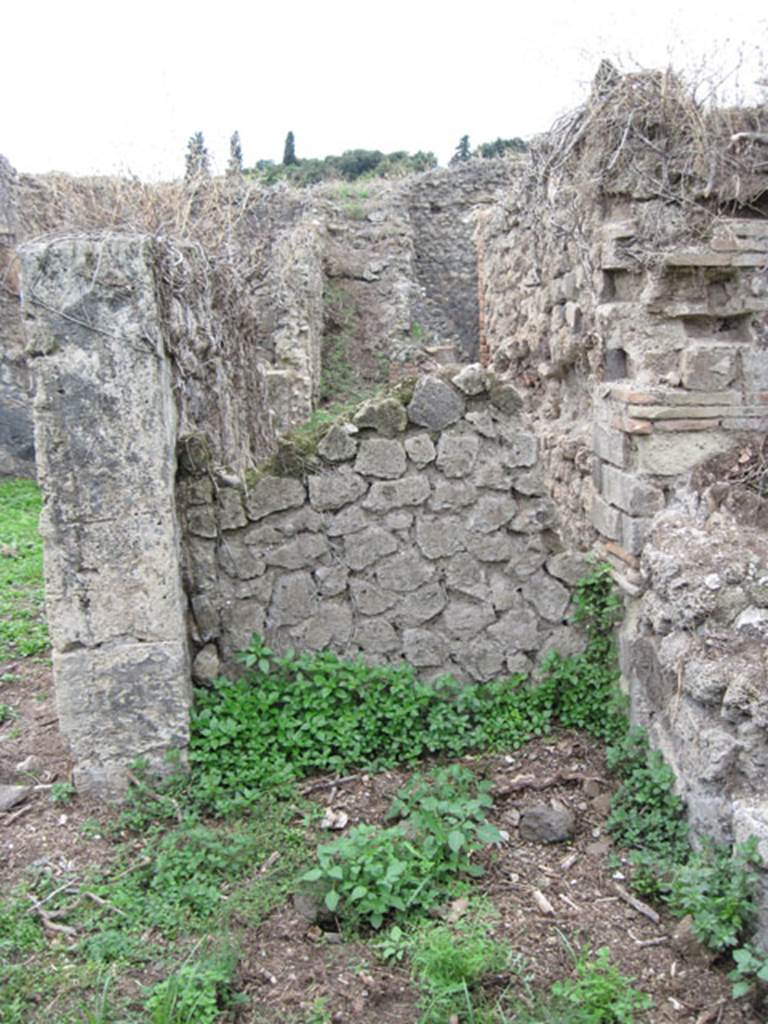 I.3.29 Pompeii. September 2010. West side of room 1, the atrium. Looking west along south wall of room 4, towards the west wall of the atrium, with a blocked doorway to I.3.30.
The doorway was blocked in antiquity. Photo courtesy of Drew Baker. See Van der Poel, H. B., 1986. Corpus Topographicum Pompeianum, Part IIIA. Austin: University of Texas. (p.6)