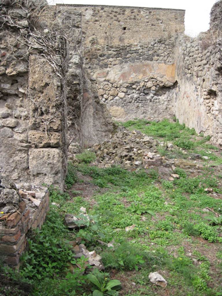 I.3.30 Pompeii. September 2010. Looking north from entrance corridor towards peristyle area. Photo courtesy of Drew Baker.
According to Jashemski, “the peristyle garden of this small house without an atrium (excavated 1872) was to the right of the north end of the entrance passageway. The garden was enclosed on the west, north, and on part of the south sides by a portico supported by columns joined by a low wall”.  See Jashemski, W. F., 1993. The Gardens of Pompeii, Volume II: Appendices. New York: Caratzas. (p.28)