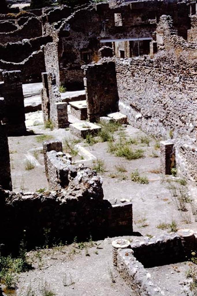 I.4.2 Pompeii. 1966. Looking from top of stairs across south portico to tablinum and atrium. 
The doorway from I.4.3 can be seen on the north (right) side of the entrance doorway of I.4.2. Photo by Stanley A. Jashemski.
Source: The Wilhelmina and Stanley A. Jashemski archive in the University of Maryland Library, Special Collections (See collection page) and made available under the Creative Commons Attribution-Non Commercial License v.4. See Licence and use details.
J66f0151