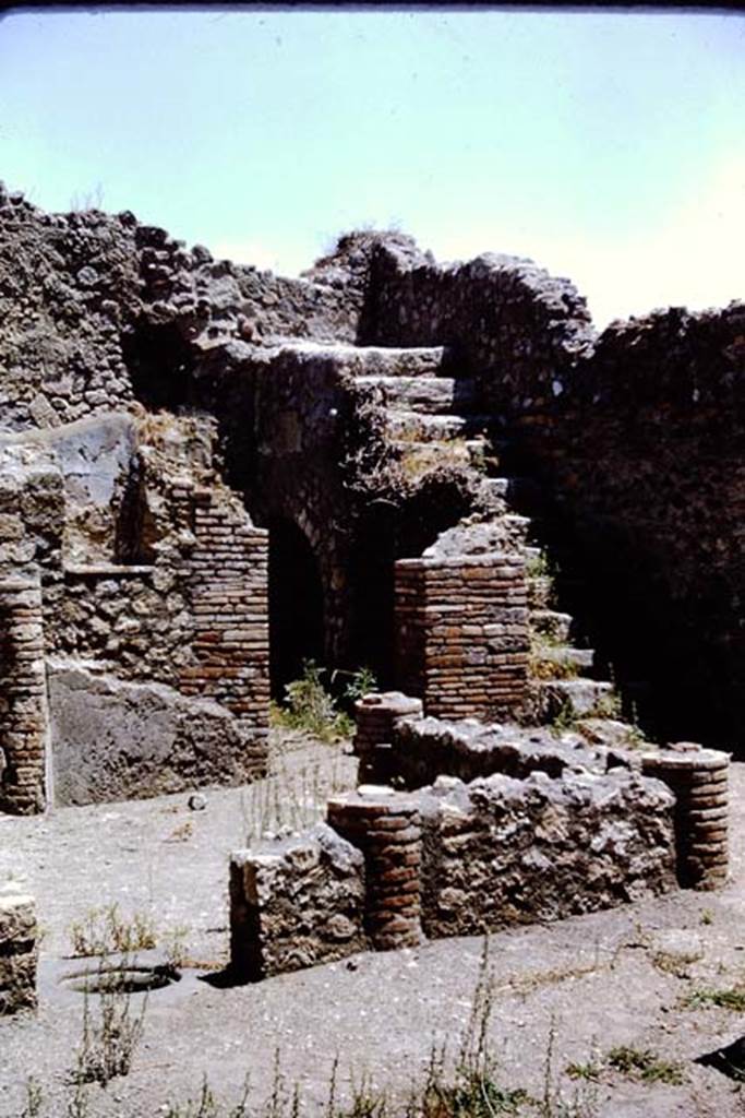 I.4.2 Pompeii. 1966. Looking towards south-east corner. Looking from tablinum across west portico, with cistern opening in entrance to peristyle, and doorway to triclinium on north side of stairs. Photo by Stanley A. Jashemski.
Source: The Wilhelmina and Stanley A. Jashemski archive in the University of Maryland Library, Special Collections (See collection page) and made available under the Creative Commons Attribution-Non Commercial License v.4. See Licence and use details.
J66f0149
