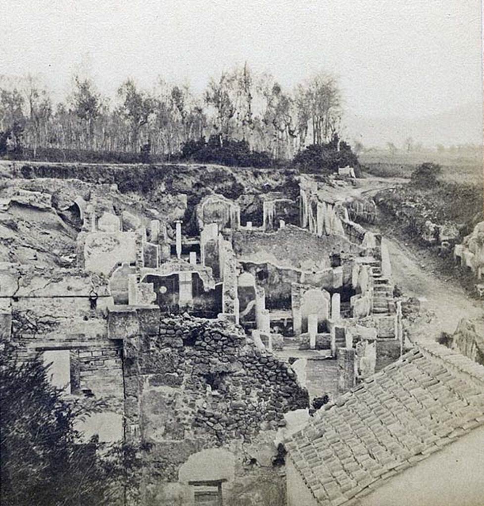 I.4.2 Pompeii. Detail from stereoview by R. Rive, c.1860-1870’s.
Looking across atrium towards peristyle at rear, and steps in south-east corner (all above the rebuilt roof in the right hand lower corner of the picture). 
At the rear of the east wall of the peristyle would be the lower (third) peristyle of 1.4.5/25.
Photo courtesy of Rick Bauer.