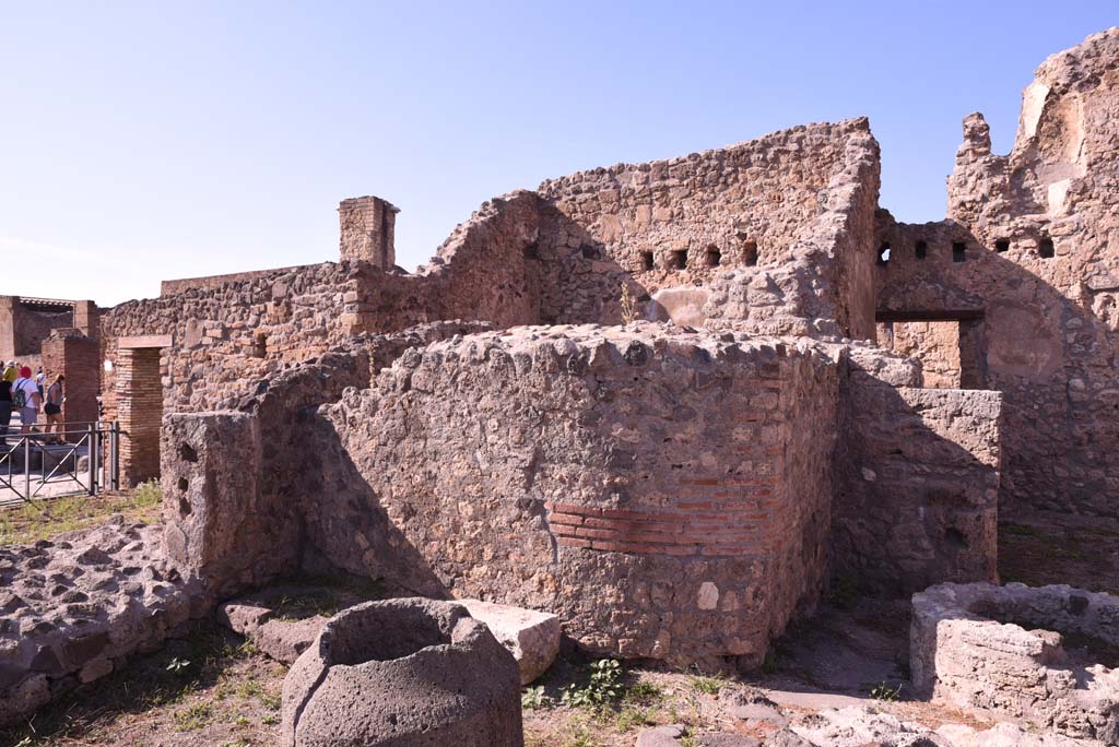 I.4.12 Pompeii. October 2019. 
Room b, bakery room, north-west corner, with rear of oven in I.4.13, in centre, and doorway into room h, on right.
Foto Tobias Busen, ERC Grant 681269 DÉCOR.