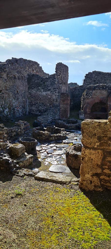 I.4.12 Pompeii. April 2022. 
Looking through doorway into room b, the bakery. Photo courtesy of Giuseppe Ciaramella.