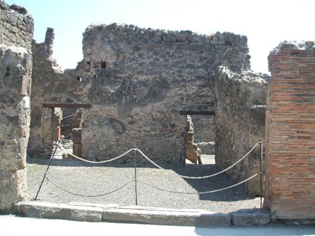 I.4.17 Pompeii. May 2005. Entrance on Via dell’Abbondanza. Looking south.
Two large terracotta dolia were found buried in the soil of the shop-room. They contained “farina molita” (flour) that Fiorelli thought was probably sold from there. They are no longer visible.
See Pappalardo, U., 2001. La Descrizione di Pompei per Giuseppe Fiorelli (1875). Napoli: Massa Editore. (p.43).
According to Della Corte, on the pilaster to the right of the shop, CIL IV 768 was found:
M.  Epidium  Sabinum  d(uumvirum) i(ure) dic(undo) o(ro) v(os) f(aciatis) dignus  est defensorem  coloniae  ex  sententia  Suedi  Clementis  sancti  Iudicis consensu  ordinis,  ob  merita  eius  et  probitatem  dignum  rei publicae  faciat(is)  Sabinus  dissignator  cum  Plausu  facit.  
See Della Corte, M., 1965.  Case ed Abitanti di Pompei. Napoli: Fausto Fiorentino. (p. 244, 
together with Note 1 – which says “For the precise topography of this programme, see PAH II, p.571)