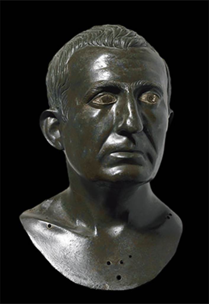 I.4.25 Pompeii. Atrium 6, floor of I.4.5 next to the tablinum, room 14. 
Portrait bronze bust of a man presumed to be one of the owners.
It is one of a pair, placed on herms in the atrium on either side of the entrance to the tablinum. 
Now in Naples Archaeological Museum. Inventory number 4989.
