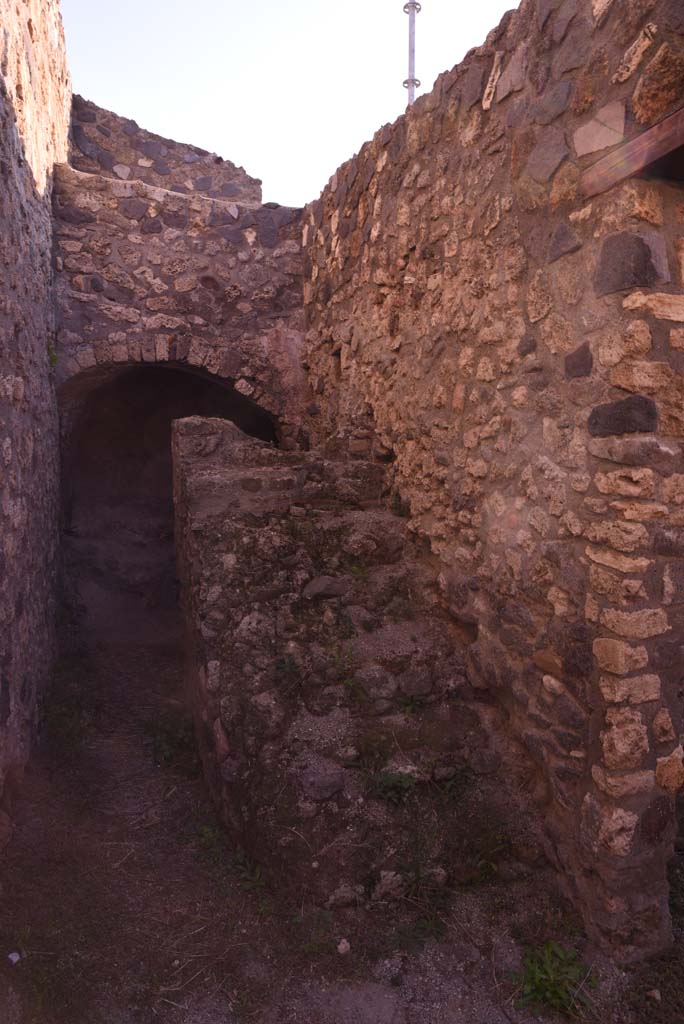 I.4.25/I.4.5 Pompeii. October 2019.  
Unnumbered corridor/room, looking east along south wall, with steps to upper floor.
Foto Tobias Busen, ERC Grant 681269 DÉCOR.