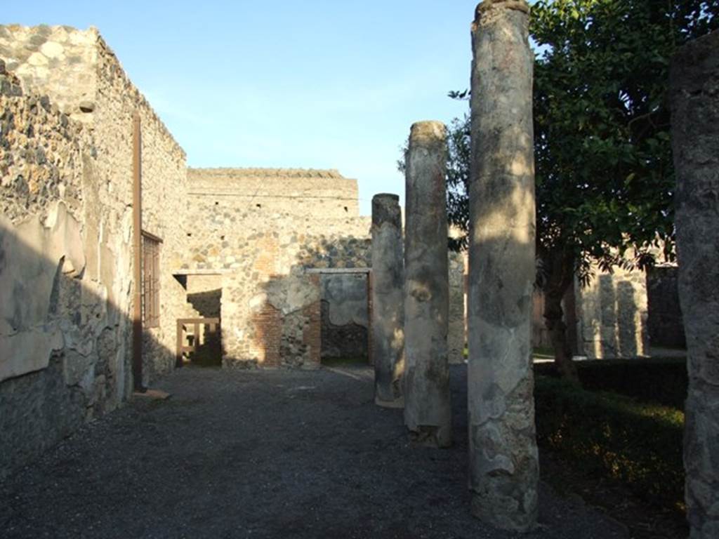 I.4.25 Pompeii. December 2007. Upper peristyle 56, looking east along north wall of upper peristyle, towards doorways to rooms 61 and 60.