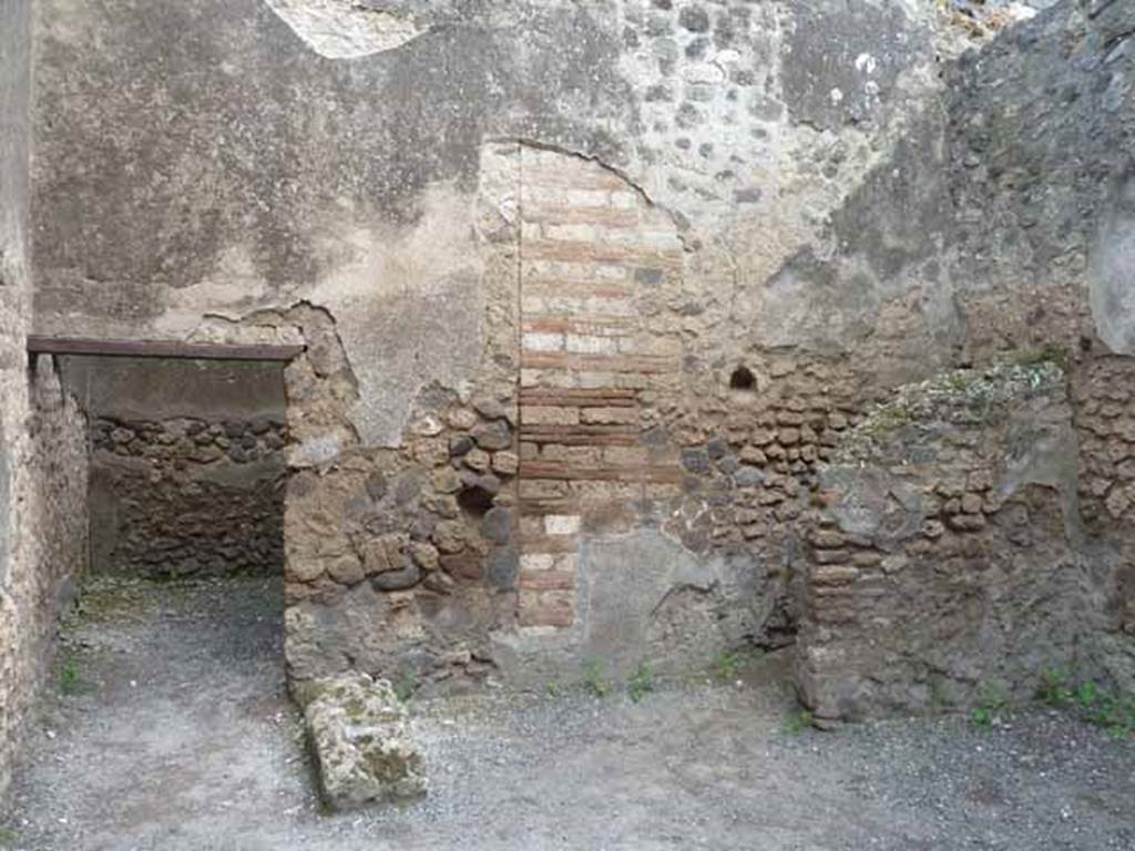 I.4.27 Pompeii. May 2010. Looking towards south wall with latrine, on right.